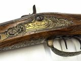 a close up of a rifle on a white surface