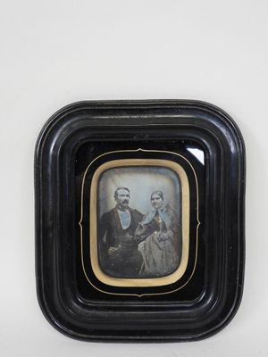 framed photograph of a man and a woman in a black frame
