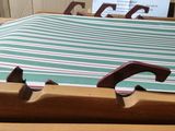 a wooden tray with a striped towel on top of it