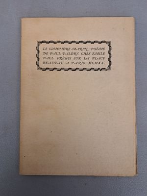 an old book sitting on top of a table next to a cup of coffee