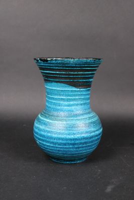 a blue vase that is sitting on a table