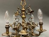 a close up of a chandelier with three lights on it
