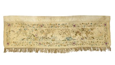 an antique embroidered table runner with floral designs and fringes