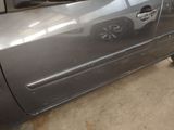 a car that has been dented and is parked in a garage
