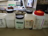 several bottles of liquid are lined up on a counter in a laboratory