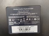 the back of a laptop computer with a wireless keyboard and mouse