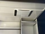 a metal cabinet with a door open in a room