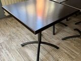 a black table with four black chairs in the room