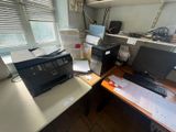 a desk with a printer, a printer and a printer on it