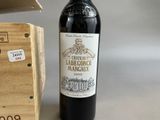a bottle of wine sitting next to a box of wine