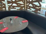 a table with place settings on it in the corner of a restaurant
