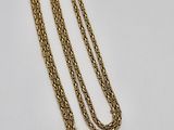 a close up of a gold chain with a tag on it