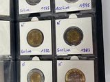 a lot of coins in a case with labels on them