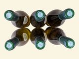 several bottles of wine are arranged in a circle on a white surface