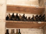 many bottles of wine sitting on the shelves in the room