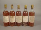 six bottles of wine are lined up in a row