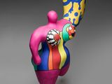 sculpture of a woman holding a vase on a pedestal