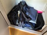several pieces of luggage are stacked on top of each other in a cabinet