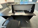 a desk with a chair and a computer on it