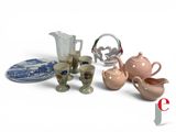 many different types of teapots and cups on the table