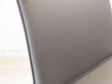 a close up of a leather chair with a white background