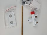 a white table with a metal pole and a red handle
