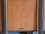 a picture of a wooden cabinet with a mirror in it
