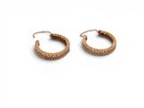 a pair of gold hoop earrings on a white background