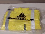 a yellow shirt that is wrapped in plastic on a table