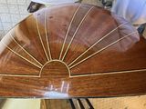 a large wooden fan on a stand in a room
