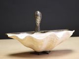 a sculpture of a bird sitting on top of a bowl