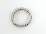 a close up of a diamond ring on a white surface
