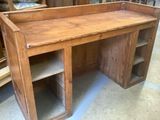 a wooden desk with a shelf on top of it