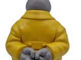 figurine of a cat in a yellow jacket holding a cup of coffee