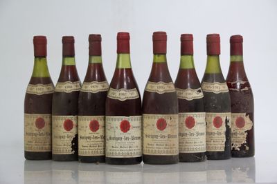 six bottles of wine are lined up in a row on a table