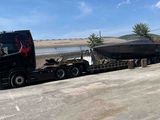 a truck that has a boat on the back of it