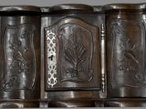 a wooden cabinet with a metal handle on the wall