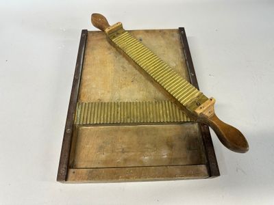 a wooden box with a knife on it and a wooden box with a knife on top of it