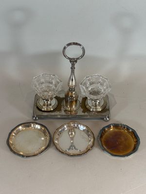 a silver tray with four glasses and a tray with sauces