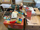 a woman sitting at a table with a lot of boxes