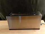 an image of a toaster sitting on a wooden table