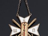 a close up of a cross on a chain on a black surface