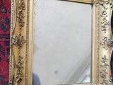 a mirror that is on the wall next to a rug
