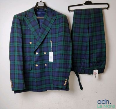 a green and blue plaid suit hanging on a wall next to a hanger
