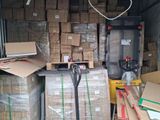 a large pile of boxes and a fork in the back of a truck