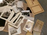 a pile of old photos on the floor of a room