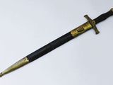 a close up of a sword on a white surface