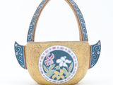 a small wooden basket with a floral design on it