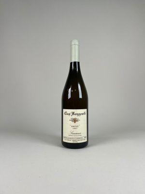 a bottle of wine sitting on top of a table next to a bottle of wine