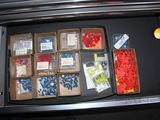 a drawer full of assorted items in the trunk of a car